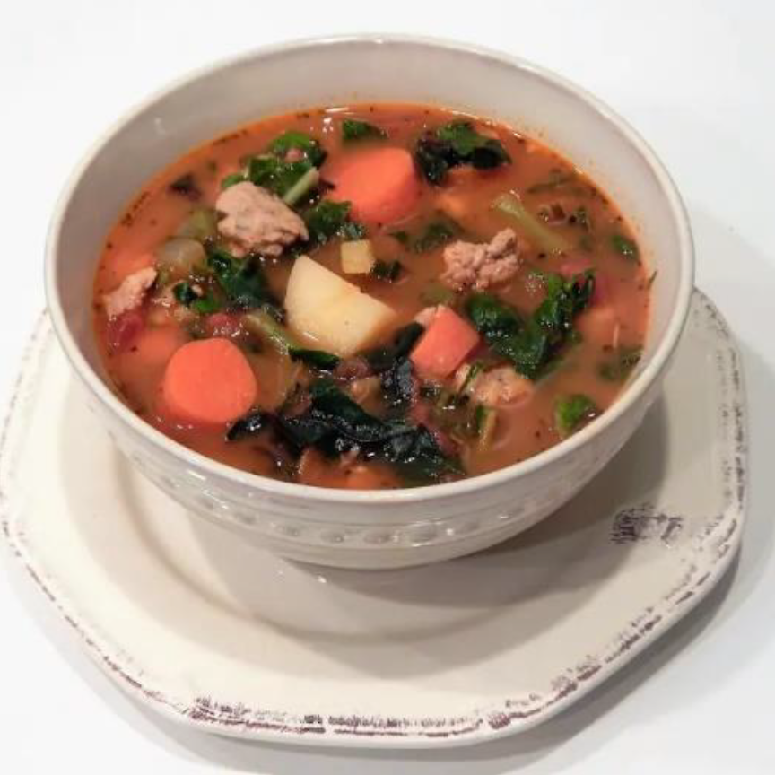 Meatball-Swiss-Chard-with-Khorasan-Wheat in a white bowl sitting on a white saucer