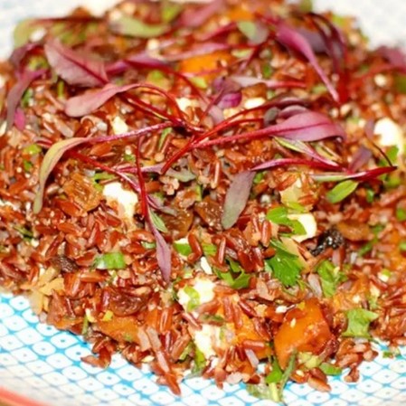 close up on red-colored stir fried vegetables with khorasan wheat